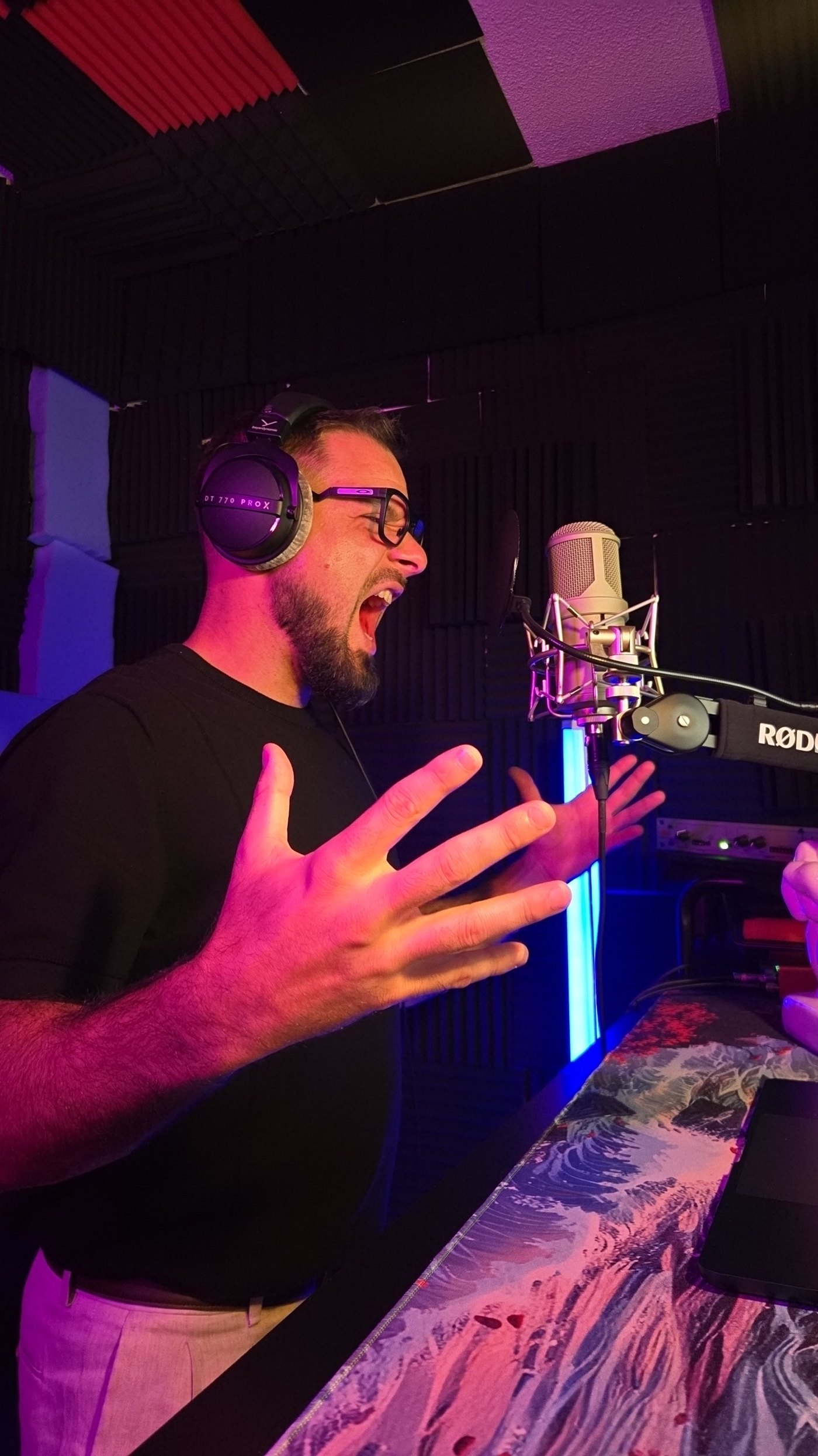 Ian Kellas performing at the microphone in his home recording booth